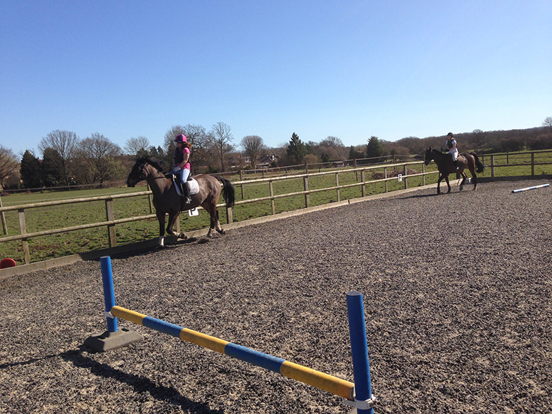 Two riders cantering at Littlefield Manor